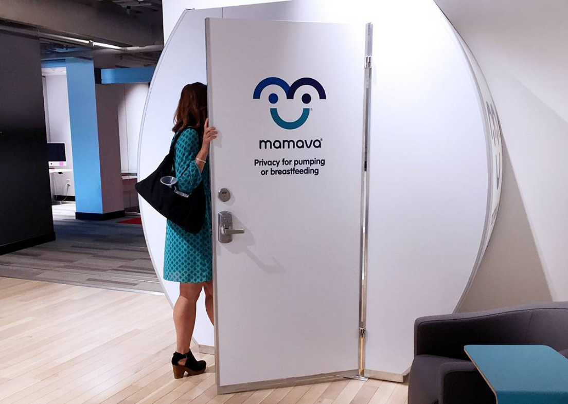 Woman in dress walking into a mamava breastfeeding pod